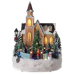 Iglesia pueblo navideño Árbol purpurina luces música 35x25x30 cm